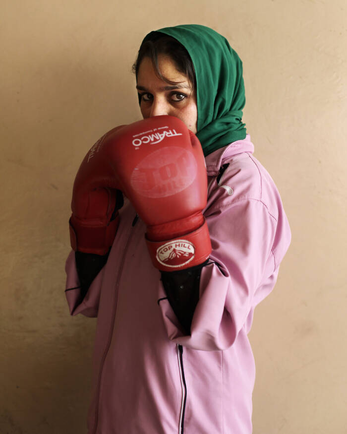 Abbie Trayler-Smith  Olympic Dreams: Fighting for Peace
Boxing is making a comeback in Afghanistan after it was banned by the Taliban Regime.  For the first time in the history of Afghanistan the country also now has an Afghan Amateur Women’s Boxing Association, financed and established by CPAU under the auspices of The Afghan Olympic Federation.
Afghanistan’s first female boxing team has fought hard to be accepted in Afghan society.  A group of teenage girls, aged 14 to 20, train 3 times a week at the dingy National Stadium in Kabul, once used for Taliban executions.  And now, with Women’s Boxing tipped to become an Olympic sport, the girls are fighting for their chance to travel to the UK as part of Afghanistan’s first female Olympic boxing team for London 2012.
.
Shabnam, 17, is one of three sisters in the team. She has been boxing since she was 11 and has already taken part in an international competition in Vietnam. She says: “I want to win a medal for myself and for my country. Afghanistan has been through a lot during my lifetime. I want to make my country proud. Why shouldn’t girls do it? In Afghanistan now we can do anything”
Saber Sharifi a fit 50-year-old who became Afghanistan’s boxing star in the 1980s by winning a silver medal at the 1982 Asia Games in Delhi, has become a champion of the programme and its coach.
“Afghan women are brave,” he said. “We want our girls to do sports. Some people say it is very dangerous for girls to do boxing. Others say Afghanistan is not ready for this. These girls are proving those people wrong.”