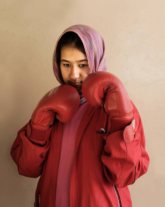 Abbie Trayler-Smith  Olympic Dreams: Fighting for Peace
Boxing is making a comeback in Afghanistan after it was banned by the Taliban Regime.  For the first time in the history of Afghanistan the country also now has an Afghan Amateur Women’s Boxing Association, financed and established by CPAU under the auspices of The Afghan Olympic Federation.
Afghanistan’s first female boxing team has fought hard to be accepted in Afghan society.  A group of teenage girls, aged 14 to 20, train 3 times a week at the dingy National Stadium in Kabul, once used for Taliban executions.  And now, with Women’s Boxing tipped to become an Olympic sport, the girls are fighting for their chance to travel to the UK as part of Afghanistan’s first female Olympic boxing team for London 2012.
.
Shabnam, 17, is one of three sisters in the team. She has been boxing since she was 11 and has already taken part in an international competition in Vietnam. She says: “I want to win a medal for myself and for my country. Afghanistan has been through a lot during my lifetime. I want to make my country proud. Why shouldn’t girls do it? In Afghanistan now we can do anything”
Saber Sharifi a fit 50-year-old who became Afghanistan’s boxing star in the 1980s by winning a silver medal at the 1982 Asia Games in Delhi, has become a champion of the programme and its coach.
“Afghan women are brave,” he said. “We want our girls to do sports. Some people say it is very dangerous for girls to do boxing. Others say Afghanistan is not ready for this. These girls are proving those people wrong.”