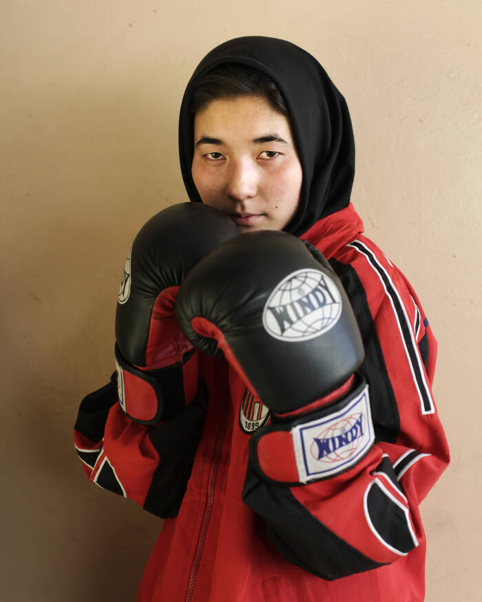 Abbie Trayler-Smith  Olympic Dreams: Fighting for Peace
Fatima Rezaee, 16, member of the Women's Boxing Team in Kabul.
Boxing is making a comeback in Afghanistan after it was banned by the Taliban Regime.  For the first time in the history of Afghanistan the country also now has an Afghan Amateur Women’s Boxing Association, financed and established by CPAU under the auspices of The Afghan Olympic Federation.Afghanistan’s first female boxing team has fought hard to be accepted in Afghan society.  A group of teenage girls, aged 14 to 20, train 3 times a week at the dingy National Stadium in Kabul, once used for Taliban executions.  And now, with Women’s Boxing tipped to become an Olympic sport, the girls are fighting for their chance to travel to the UK as part of Afghanistan’s first female Olympic boxing team for London 2012.
.
Shabnam, 17, is one of three sisters in the team. She has been boxing since she was 11 and has already taken part in an international competition in Vietnam. She says: “I want to win a medal for myself and for my country. Afghanistan has been through a lot during my lifetime. I want to make my country proud. Why shouldn’t girls do it? In Afghanistan now we can do anything”Saber Sharifi a fit 50-year-old who became Afghanistan’s boxing star in the 1980s by winning a silver medal at the 1982 Asia Games in Delhi, has become a champion of the programme and its coach.
“Afghan women are brave,” he said. “We want our girls to do sports. Some people say it is very dangerous for girls to do boxing. Others say Afghanistan is not ready for this. These girls are proving those people wrong.”